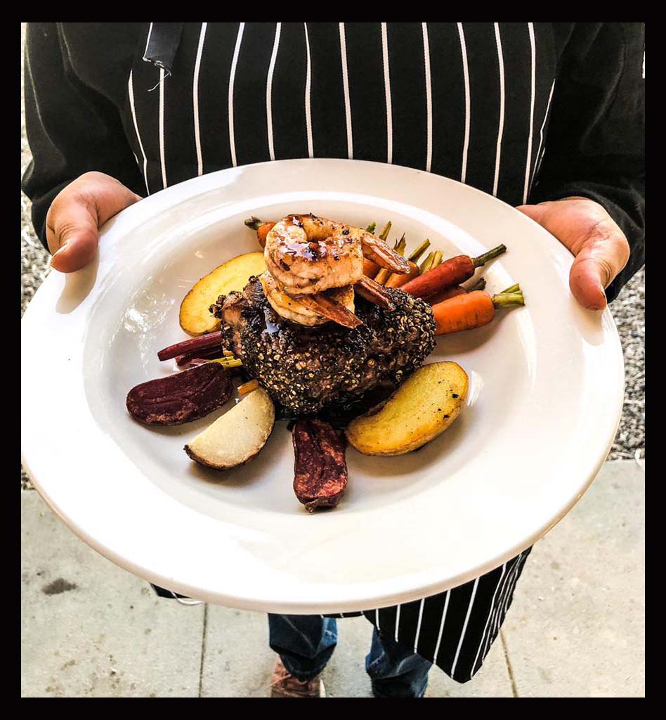 Top sirloin medallion with 3 tiger prawns young potatoes roasted swiss chard, caramelized baby carrots and merlot reduction